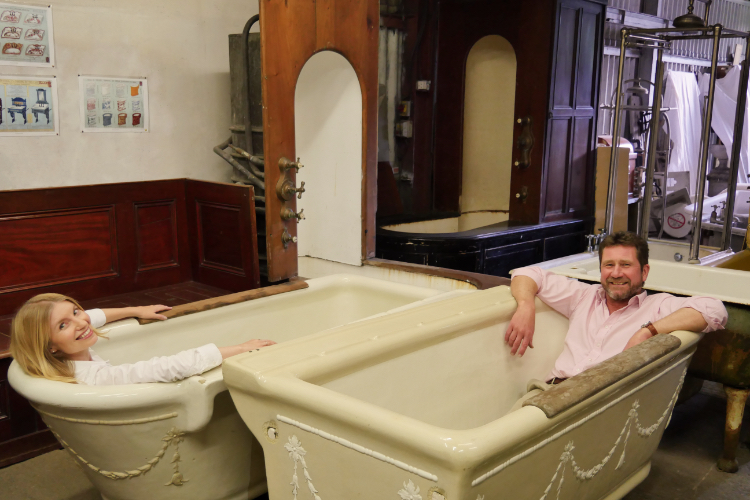 Presenters of the video tour Sara Morel and Simon Kirby enjoying the antique baths